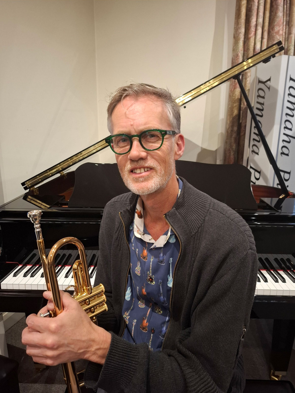 Mark Barratt sits at a piano at The NAMM Show