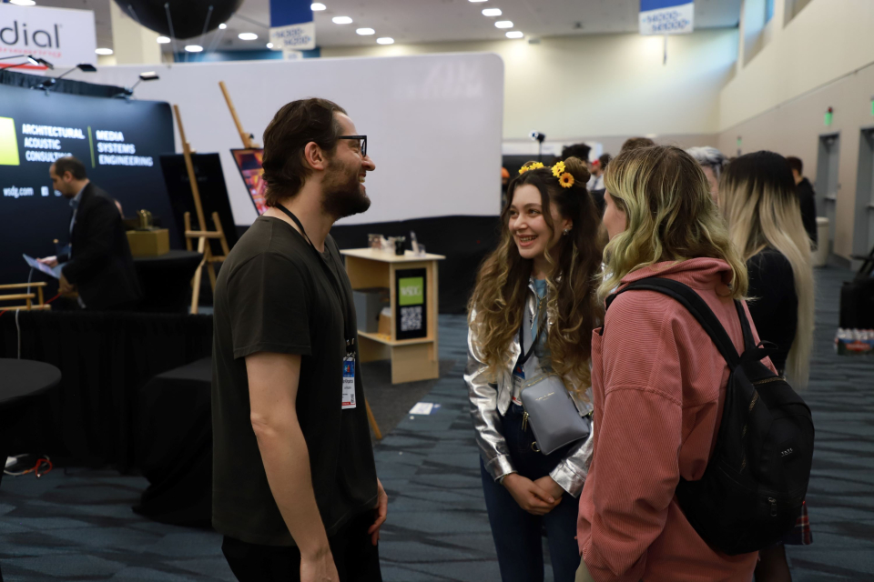 namm show exhibitor with attendees
